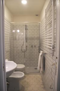 a bathroom with a shower and a toilet and a sink at Guest House Interno4 in Rome