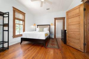 a bedroom with a bed and a ceiling fan at Be A Nomad - Combined Pool Home 1 blck to Beach in Jacksonville Beach +24 photos