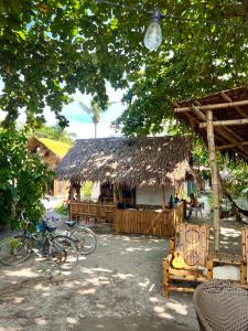 a building with a straw hut with bikes parked in front at Tribal Huts Community in Malapascua Island