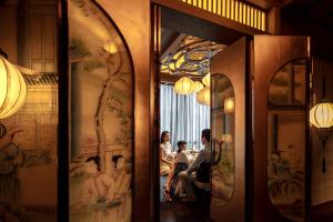 a group of people in a room with paintings on the walls at The Ritz-Carlton, Chengdu in Chengdu