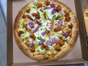 a pizza in a cardboard box with a pizza at thurai guest house in Jaffna