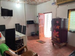 a room with a kitchen with a refrigerator and a door at thurai guest house in Jaffna