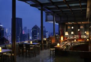 a restaurant with tables and chairs and a view of the city at The Ritz-Carlton, Chengdu in Chengdu