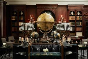 a library with a large orb on a table at 41 in London