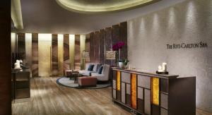 a lobby with a waiting area with chairs and a table at The Ritz-Carlton, Chengdu in Chengdu