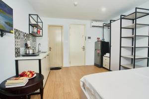a room with a bed and a table with fruit on it at Eco Nest Hotel & Apartment in Hanoi