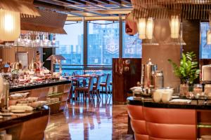 a restaurant with a view of the city at The Ritz-Carlton, Chengdu in Chengdu
