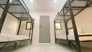 two bunk beds in a room with a mirror at SimoyNorte Private Resort Beneg, Botolan, Zambales, Philippines in Zambales +57 photos
