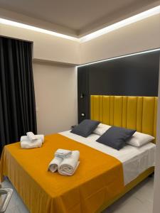 a bedroom with a large bed with towels on it at Luxury Home Station in Tropea
