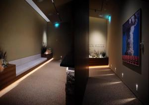 a dark room with a bench and a table in it at UH Suite The Gangnam in Seoul +36 photos