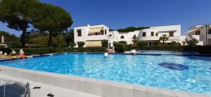 a large swimming pool in front of a house at Villetta Moro Mesele in Lido di Jesolo