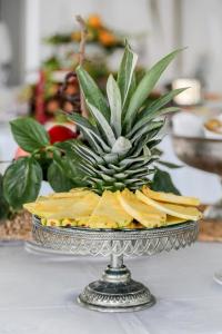 a pineapple sitting on top of a plate on a table at Hotel Villa Lubrense Sorrento in Massa Lubrense