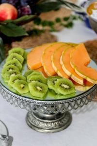 a plate of fruit and vegetables on a table at Hotel Villa Lubrense Sorrento in Massa Lubrense