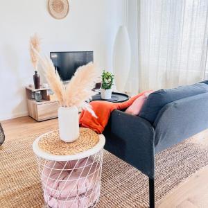 a living room with a blue couch and a table at zenitude in Marquette-lès-Lille