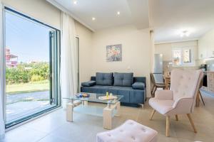 a living room with a blue couch and a table at Luxury Suite in River in Potamós