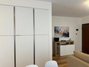 a living room with white walls and a large glass partition at Iris home in Favaro Veneto +13 photos