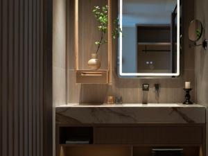 a bathroom with a sink and a mirror at Yanyu Yunxi Resort Hotel 烟雨云兮酒店 in Fenghuang County