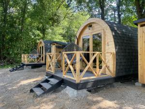 a group of wooden play houses in a yard at Gościn nad Drawą Glamping in Drawno