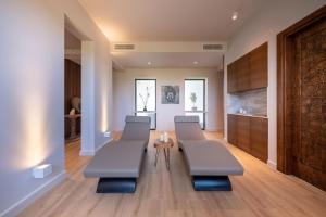 a dining room with benches and a table at Thalassa Beach Resort in Vokolidha