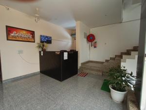 a lobby with a staircase and a stair case at Hotel Mehra Inn in Haldwāni