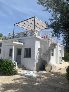 a white house with stairs and a roof at Villas Ermali in Ksamil