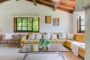 a living room with a couch and a table at Elysian Villa in Miño