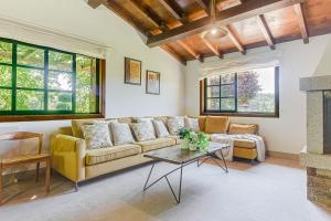 a living room with a couch and a table at Elysian Villa in Miño
