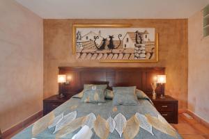 a bedroom with a large bed and two lamps at Atalaya in Santa Eulalia la Mayor +23 photos