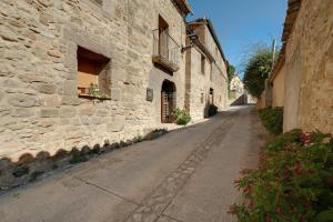 an empty street in an old stone building at Atalaya in Santa Eulalia la Mayor