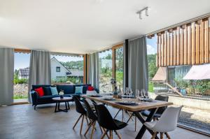 a living room with a table and chairs at Architektenhaus c1 mit Seesicht in Öhningen