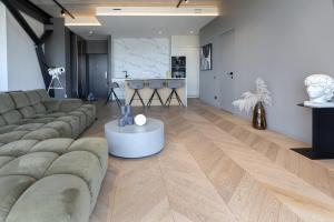 a living room with a couch and a table at HOUSE38 Panoramic View Apartments SELF CHECK-IN in Kaunas
