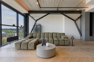 a living room with a couch and a table at HOUSE38 Panoramic View Apartments SELF CHECK-IN in Kaunas +20 photos