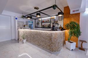 a bar in a restaurant with a large marble counter at Hotel Elite Sarande in Sarandë