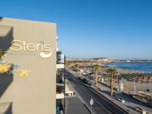 a sign on a building with a view of a street at Steris Elegant Beach Hotel in Rethymno +29 photos