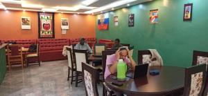 a woman sitting at a table in a restaurant at jc iten in Iten