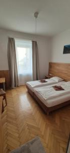 a bedroom with two beds and a window at Pension Jahn in Salzburg