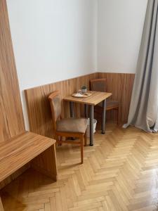 a small table and chairs in a room at Pension Jahn in Salzburg +9 photos