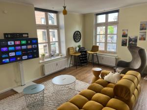 a living room with a couch and a tv at Sunny Side Straelen, 110 qm in Straelen