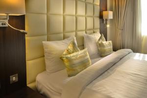 Een bed of bedden in een kamer bij Golden Ocean Hotel