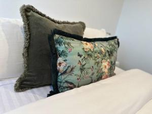 a pillow sitting on top of a couch at Hagley Park Retreat in Christchurch