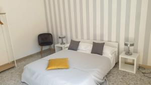 a bedroom with a bed with a yellow pillow on it at sorrento joy in Sorrento