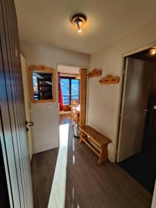 einen Flur mit Tür und Bank in einem Zimmer in der Unterkunft Condo in val thorens by AlpStays in Val Thorens