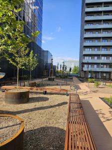 a park with benches and trees and buildings at LOCUS SKY TOWER Katowice in Katowice +2 photos