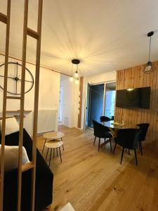 a room with a bunk bed and a table and chairs at Oaza in Sarajevo