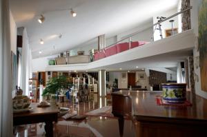 a large living room with a staircase in a house at B&B Cà d'Artisti in Caorle