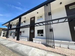 a large building with black and white at H Mansion Hotel in Tandag