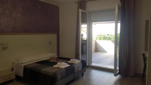 Ένα ή περισσότερα κρεβάτια σε δωμάτιο στο La Dea Rooms