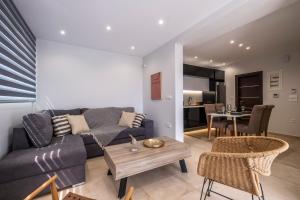 a living room with a couch and a table at Orion Luxury Apartments in Nafplio