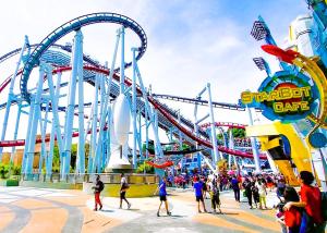 a group of people walking around a roller coaster at Bukit Beruntung Hotel in Rawang