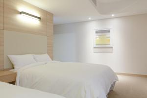 Łóżko lub łóżka w pokoju w obiekcie Acube Hotel Dongdaemun